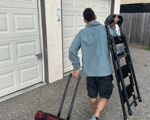 Garage Door Repair Huntington Beach 28 carlos garage door technician carrying a stair to service a garage door in huntington beach